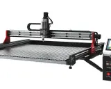 A CNC milling machine with a touch screen control box.