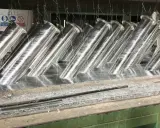 Tubi metallici immersi in un bagno, pronti per la zincatura. La lega di zinco conferirà loro resistenza alla corrosione.