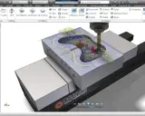 Simulazione CAM di Autodesk: un utensile lavora un pezzo con percorsi di taglio complessi, mostrando cos'è Autodesk per la produzione.